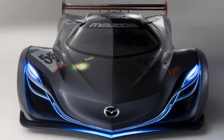 Sleek Mazda Furai vehicle, front view in black with glowing blue accents, high-detail HD PC desktop wallpaper background.