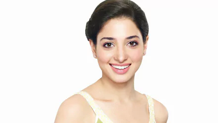 HD desktop wallpaper of celebrity Tamannaah Bhatia smiling against a plain white background.