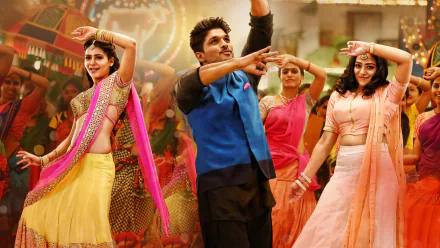 A vibrant HD wallpaper featuring Nithya Menen, Samantha Akkineni, and Allu Arjun in a colorful dance scene from the movie S/O Satyamurthy.