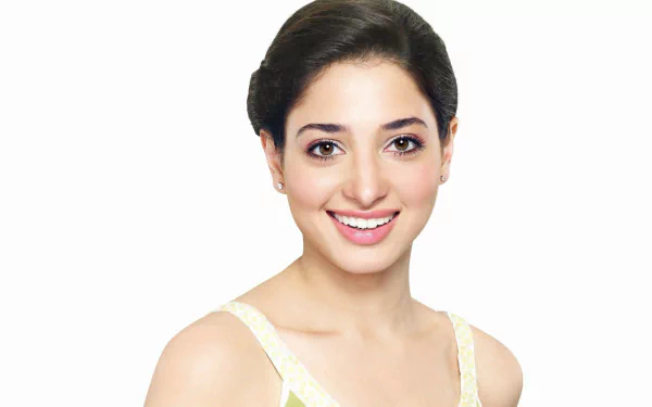 HD desktop wallpaper of celebrity Tamannaah Bhatia smiling against a plain white background.