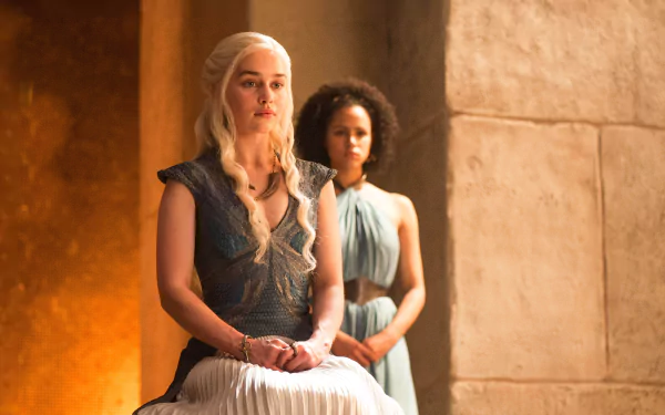 HD desktop wallpaper featuring Daenerys Targaryen (Emilia Clarke) from the TV show Game of Thrones, with Daenerys seated and another character standing behind her in a stone-walled setting.