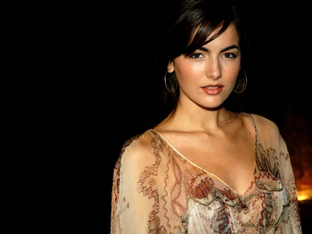 HD desktop wallpaper featuring celebrity Camilla Belle in a sheer, patterned top against a dark background.