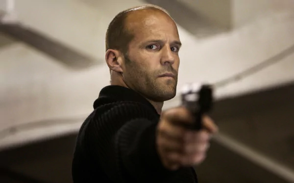 HD desktop wallpaper featuring Jason Statham aiming a gun in a scene from the movie The Mechanic.