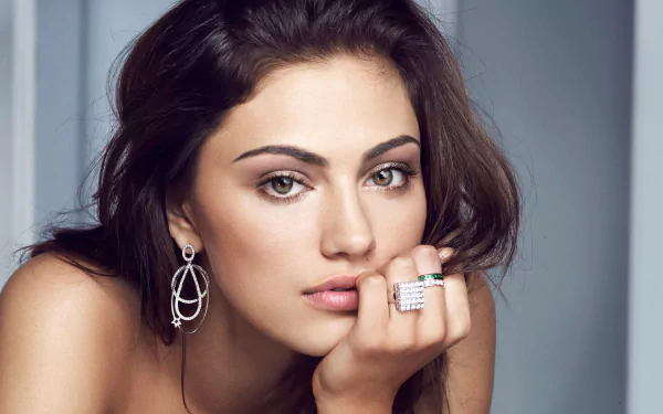 HD desktop wallpaper featuring a close-up portrait of celebrity Phoebe Tonkin with natural makeup and elegant jewelry against a soft, neutral background.