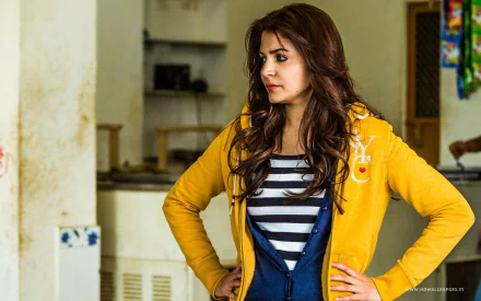 A striking HD wallpaper featuring Anushka Sharma in her role from the movie NH10, showcasing her in a yellow hoodie with a serious expression against an indoor backdrop.
