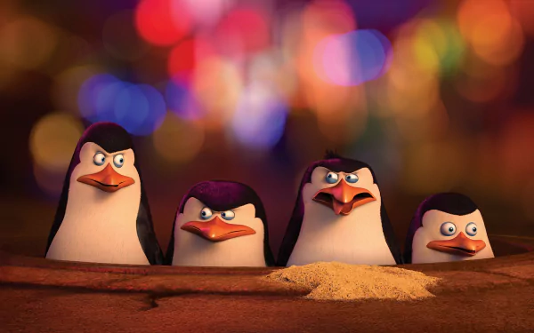 HD wallpaper featuring characters from the movie Penguins of Madagascar, with the four penguins standing in front of a colorful blurred background.