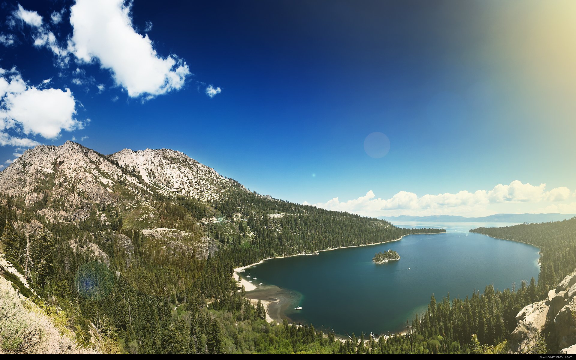 HD PC desktop wallpaper and background: panoramic nature landscape of a mountain lake with forested shoreline, a small island, rocky peaks and a clear blue sky.