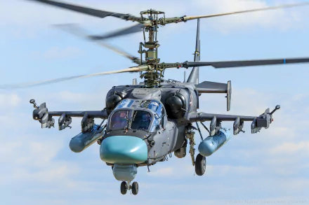 A striking HD wallpaper featuring the Kamov Ka-52 Alligator military helicopter in action, showcasing its advanced design and weaponry against a blue sky backdrop.