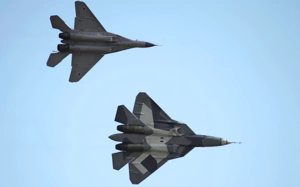Two advanced military jets, the Mikoyan Gurevich MiG-35 and Sukhoi Su-57, soaring through a clear blue sky, showcased in a vibrant HD desktop wallpaper.