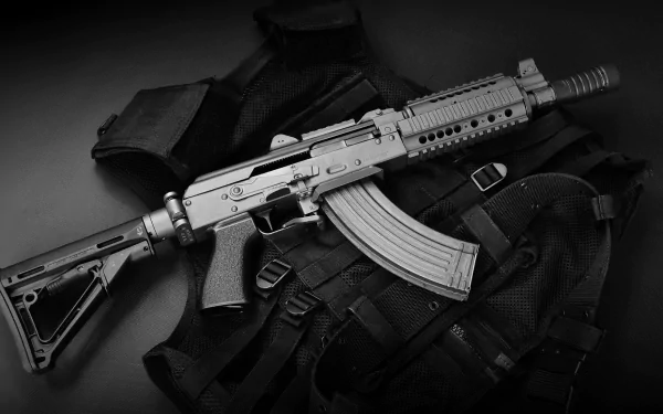 HD desktop wallpaper showing a man-made rifle resting on tactical gear in a monochrome black-and-white style.