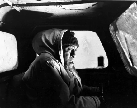 2K Quad HD PC desktop wallpaper/background — black-and-white still from the movie The Shining: bundled man in a knit cap stares out from inside a car.