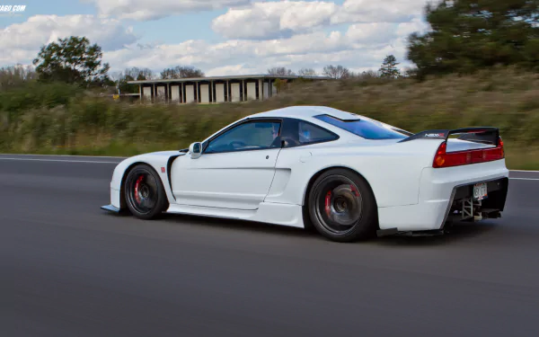 White Honda NSX vehicle speeding along a highway with motion-blurred road and clouds — HD PC desktop wallpaper/background.