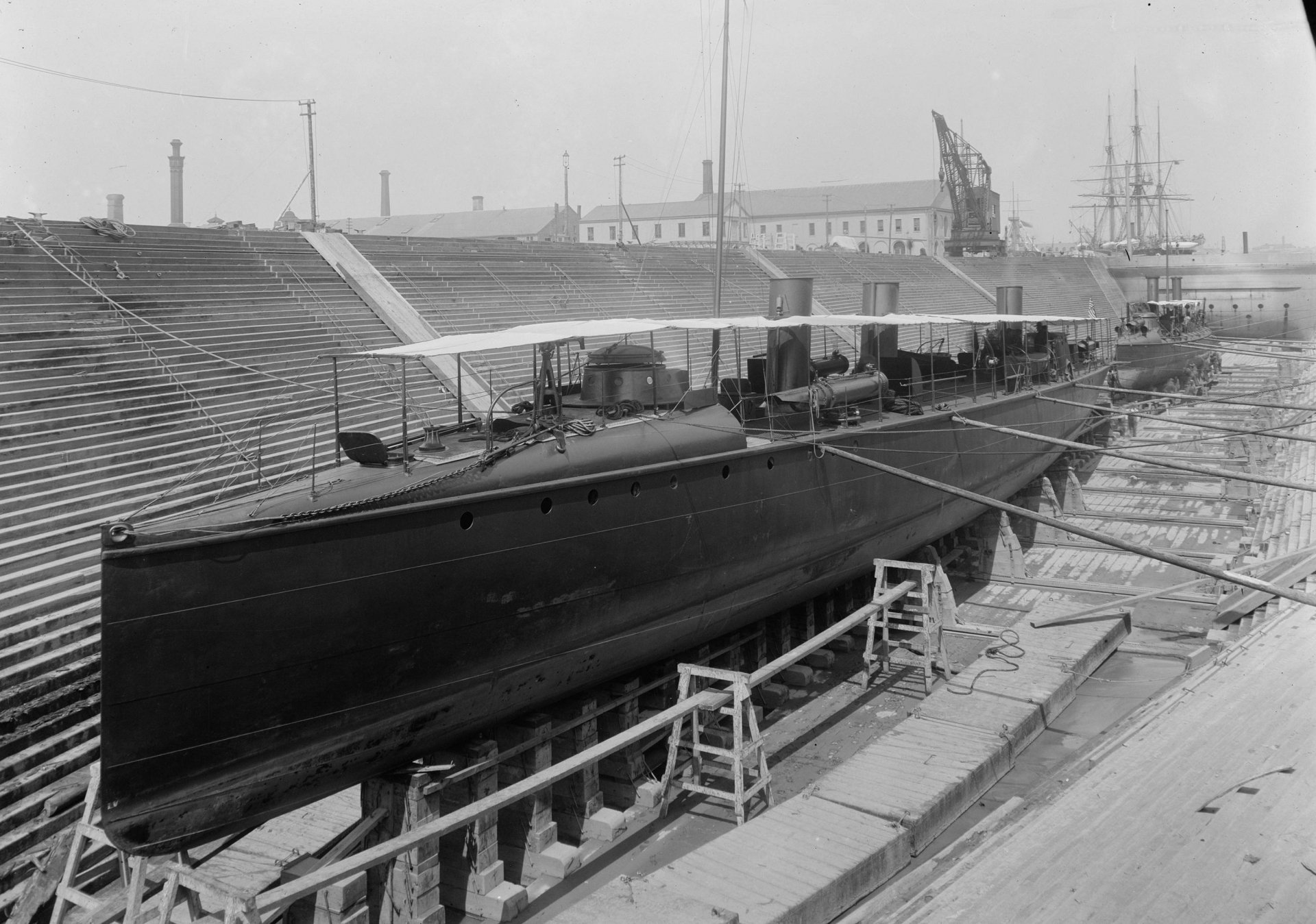 Black-and-white image of the military torpedo boat USS Ericsson (TB-2) in drydock, vintage naval scene — 2K Quad HD PC desktop wallpaper and background