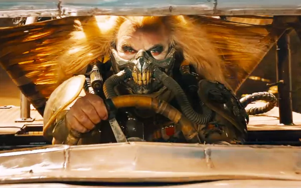 HD PC desktop wallpaper featuring Immortan Joe, portrayed by Hugh Keays-Byrne, from the movie Mad Max: Fury Road, gripping the steering wheel in a desert setting.