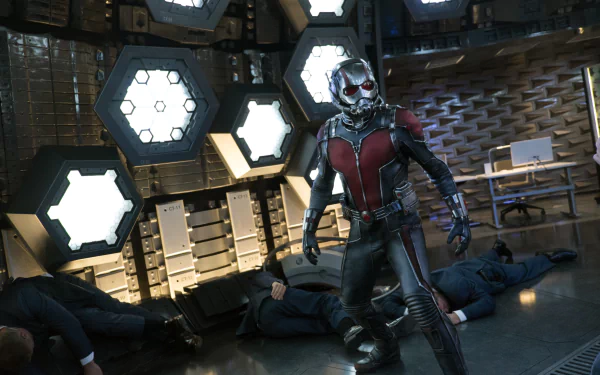 Ant-Man stands in a high-tech room with fallen foes around him, showcased in a 4K Ultra HD PC desktop wallpaper from the Ant-Man movie.