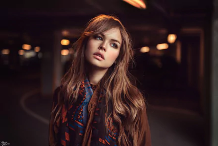 A high-definition desktop wallpaper featuring a woman in a parking lot, illuminated by soft lighting. The image captures the woman's contemplative expression and is tagged with Anastasiya Scheglova.