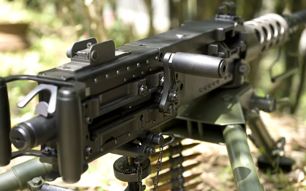 Close-up of a machine gun, showcasing its intricate design and detailing. This HD desktop wallpaper highlights the man-made engineering behind the weaponry.
