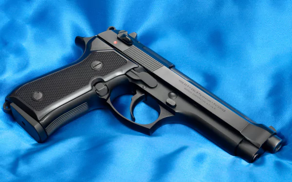 Man-made Beretta 92F pistol on blue satin, high-detail 2K Quad HD PC desktop wallpaper/background.