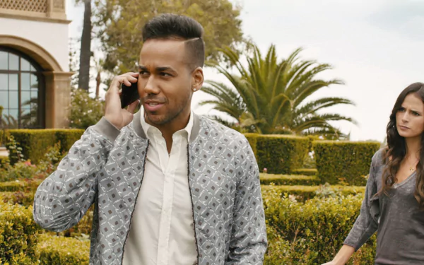 Mia Toretto and a character from Furious 7 stand outside a luxury home. The backdrop features lush greenery, creating an engaging HD desktop wallpaper setting.