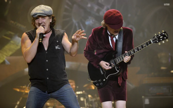 A powerful HD wallpaper showcasing AC/DC in action, featuring dynamic performances from the iconic heavy metal band, capturing the energy and passion of their music.
