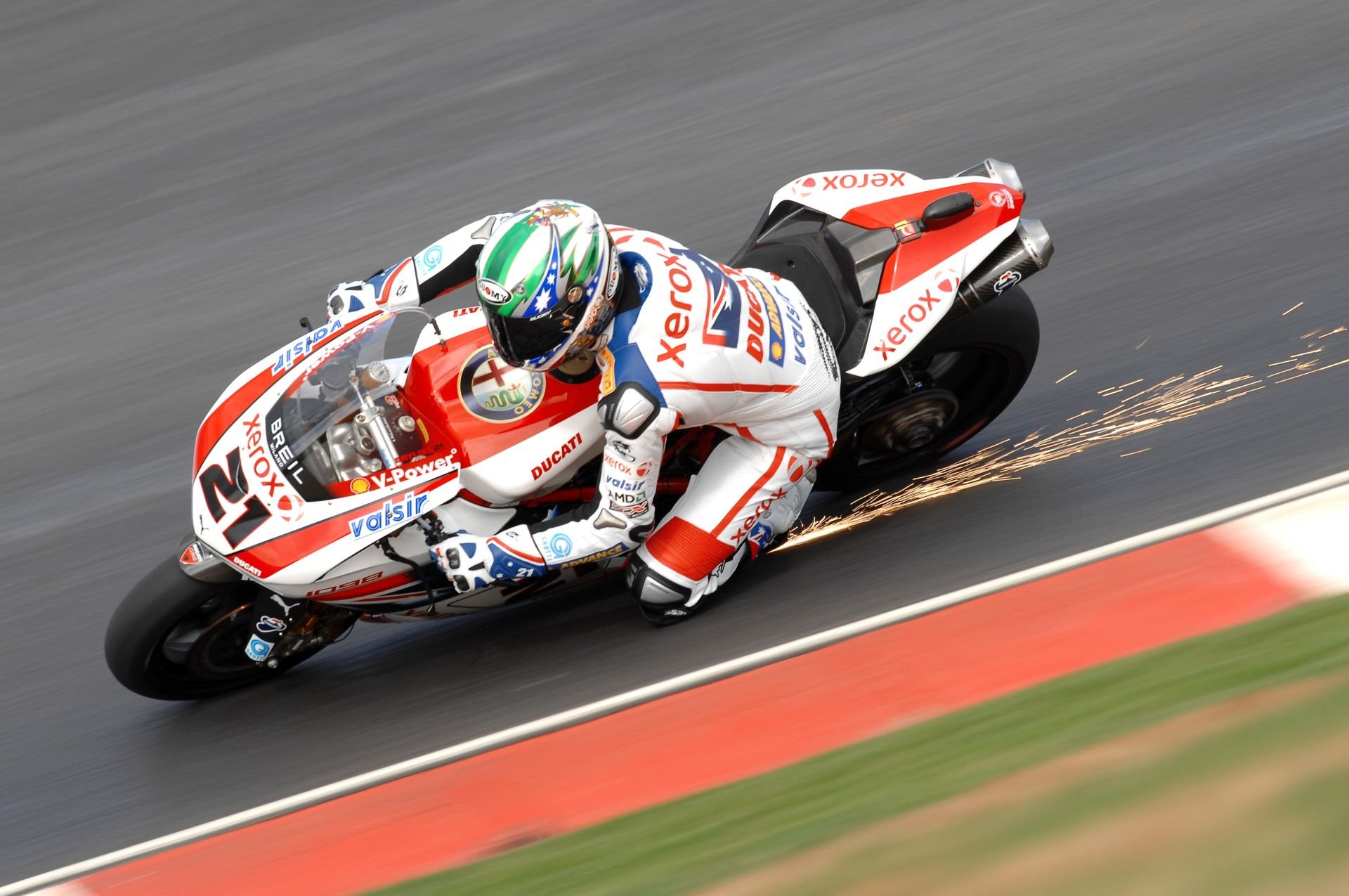 HD PC desktop wallpaper featuring a motorcycle racer leaning into a turn, sparks flying as the bike speeds along the track.