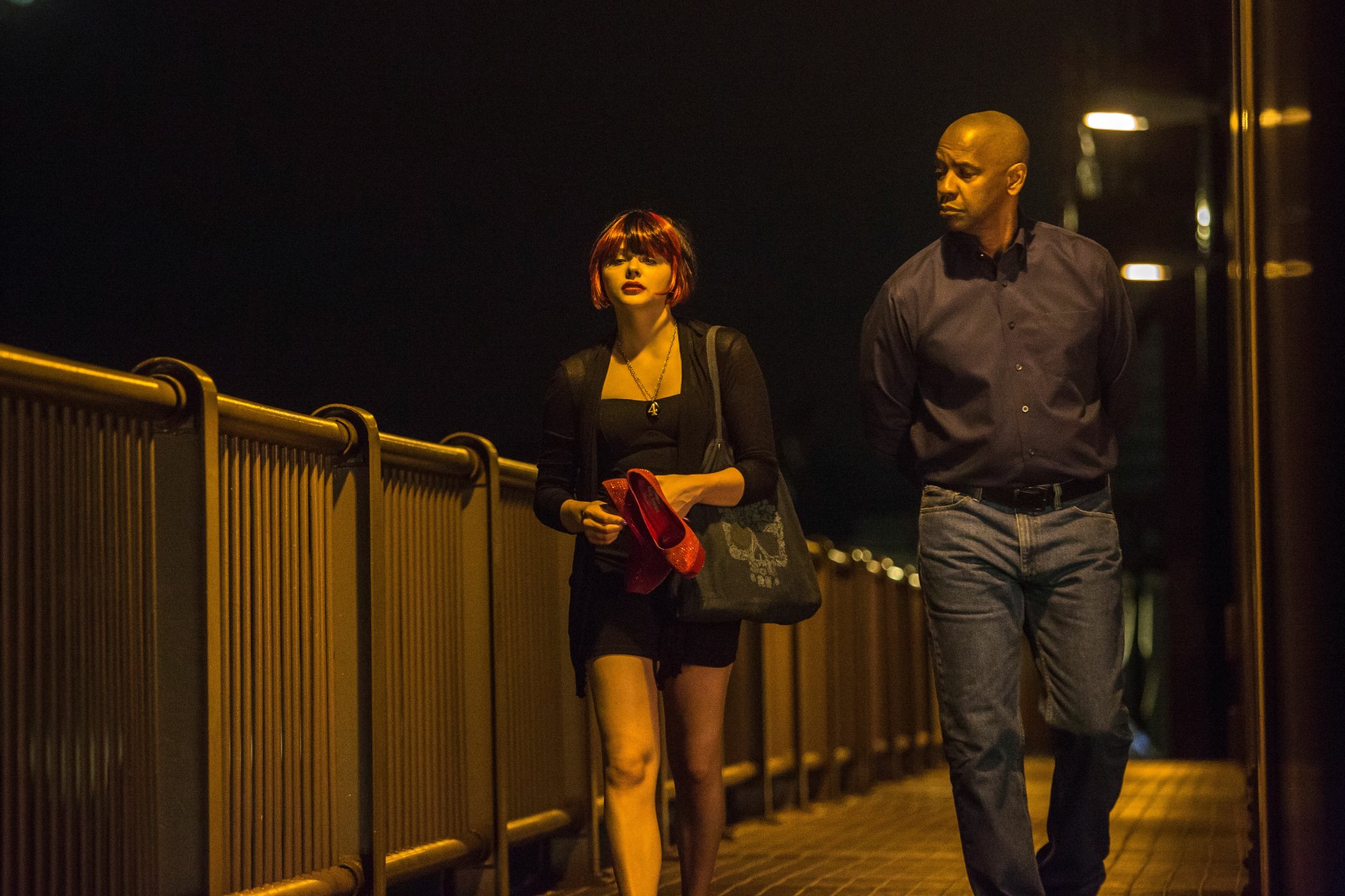 Denzel Washington and Chloë Grace Moretz walk along a dimly lit bridge in a scene from The Equalizer, presented as a 4K Ultra HD PC desktop wallpaper.
