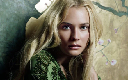 HD PC desktop wallpaper featuring celebrity Diane Kruger with long blonde hair, wearing a green patterned top, against a soft, artistic floral background.