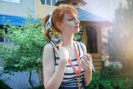 HD PC desktop wallpaper/background of a redheaded woman (tag withheld), striped top and layered necklaces, standing outdoors by greenery with sunlight and a house in the background.