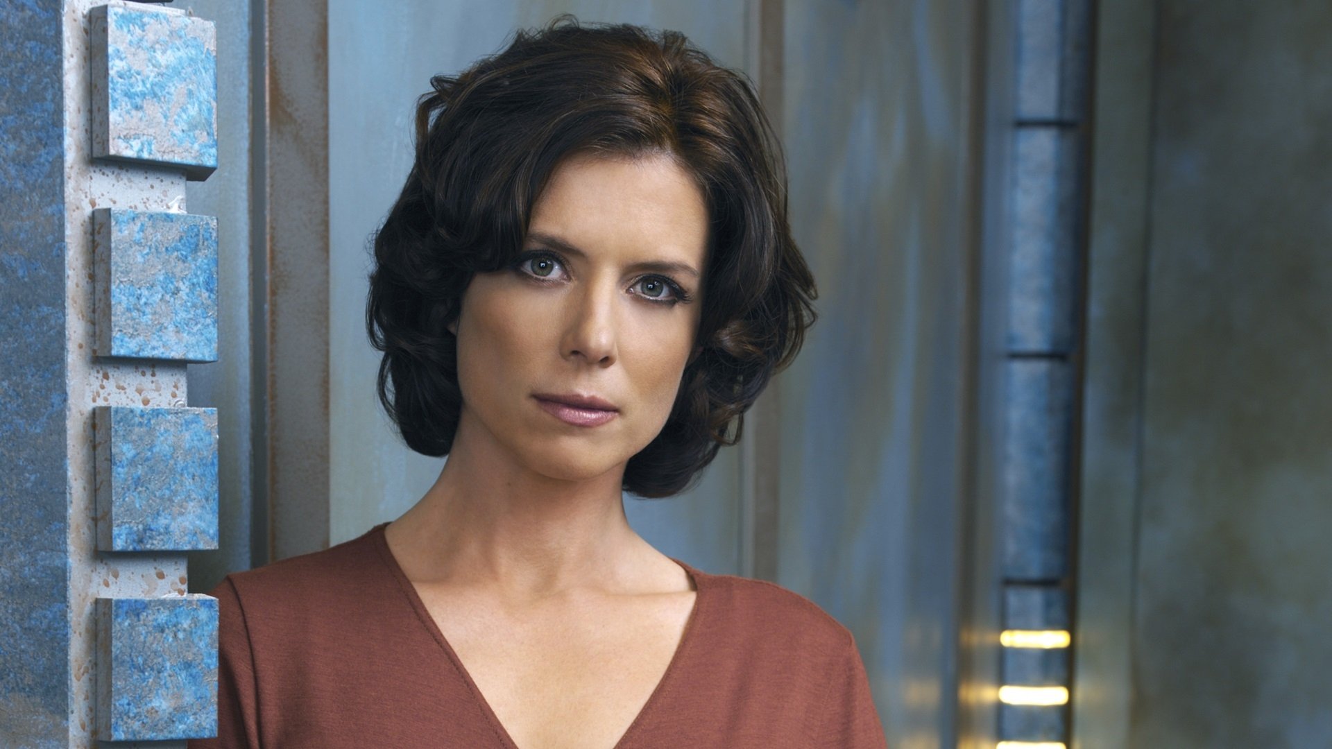 HD PC desktop wallpaper featuring a character from the TV show Stargate Atlantis standing against a sci-fi backdrop.