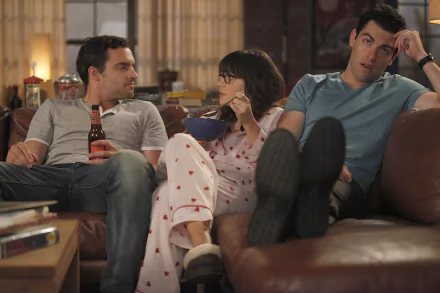 HD desktop wallpaper from the TV show New Girl: Schmidt, Nick Miller and Jessica Day lounging on a couch, Jess in pajamas in a cozy living-room scene.