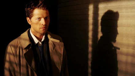 HD PC desktop wallpaper featuring a character from the TV show Supernatural, standing against a shadowed wall with dramatic lighting.