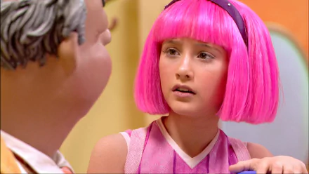 HD PC desktop wallpaper from the TV show LazyTown: close-up of a pink-haired girl in a pink outfit looking toward a blurred figure against a bright set background.