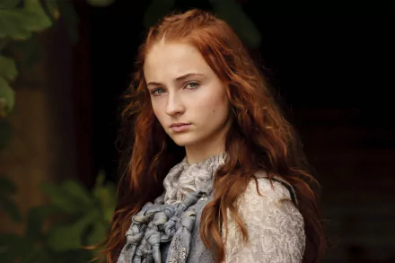 HD desktop wallpaper featuring Sophie Turner as Sansa Stark from the TV show Game of Thrones, showcasing her with long, curly red hair and a serious expression.