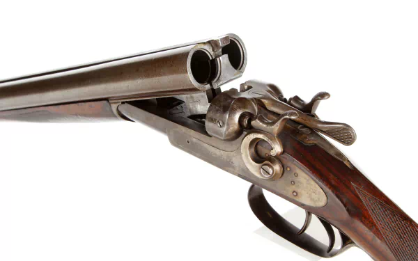 Close-up of a man-made double-barrel shotgun with intricate metal and wood detailing, presented in 4K Ultra HD as a PC desktop wallpaper and background.