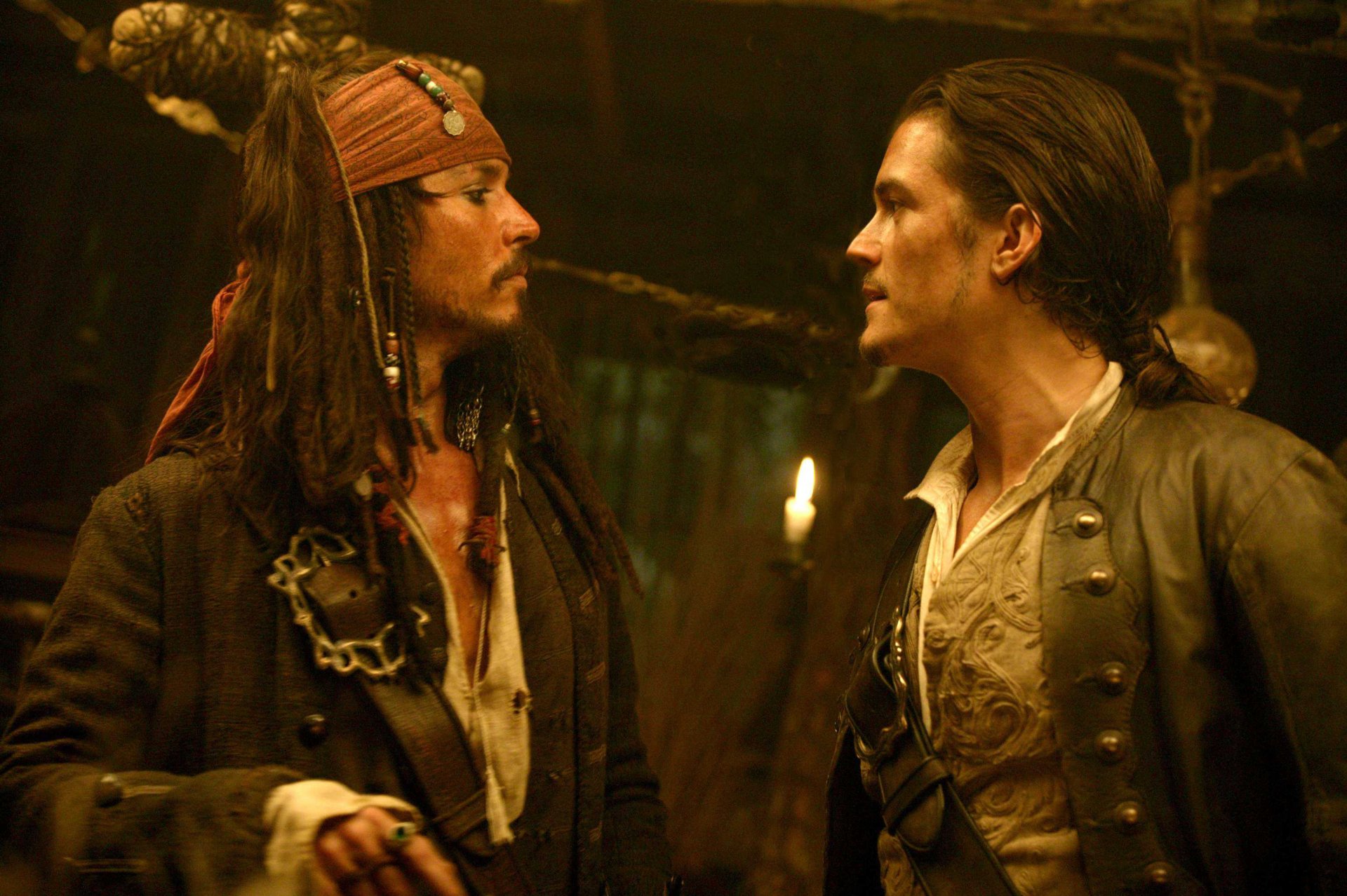 HD desktop wallpaper featuring Johnny Depp as Jack Sparrow and Orlando Bloom as Will Turner from the movie Pirates of the Caribbean: Dead Man's Chest.