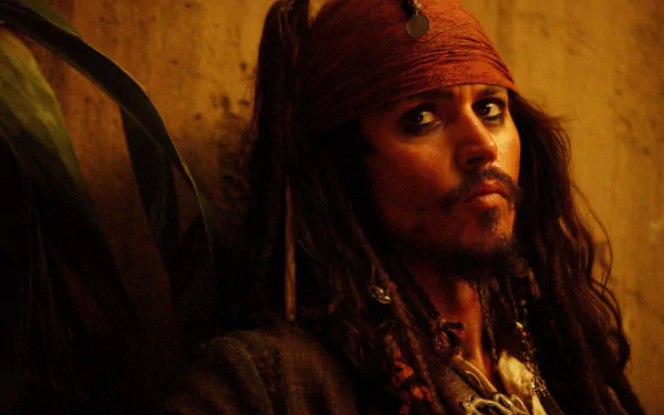 HD wallpaper featuring Jack Sparrow, portrayed by Johnny Depp, from the movie Pirates of the Caribbean: Dead Man's Chest, showcasing his iconic look against a warm, textured background.