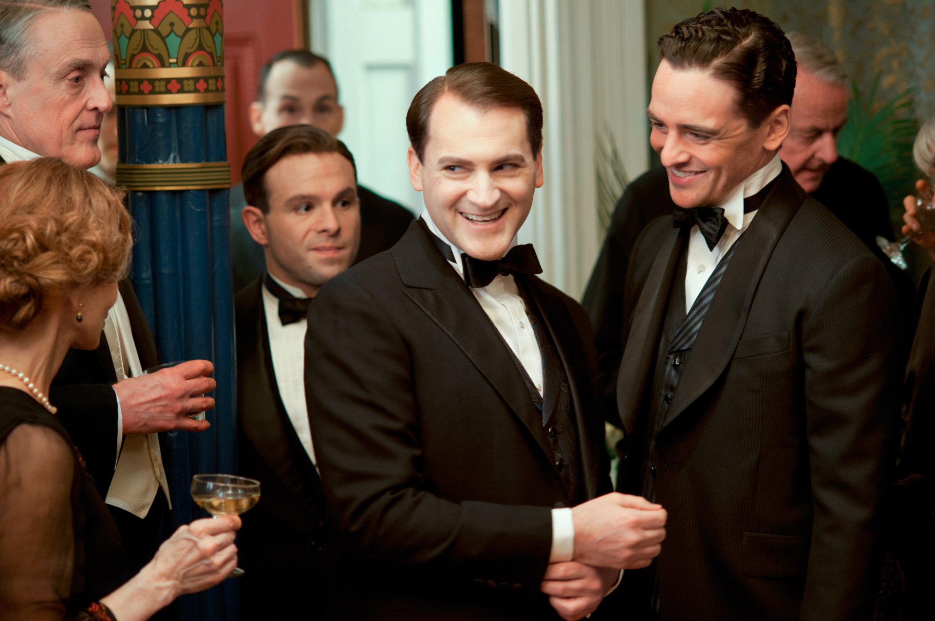Boardwalk Empire TV show HD PC desktop wallpaper and background: men in 1920s tuxedos laughing at an elegant party, holding champagne amid ornate Art Deco décor.
