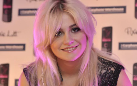 HD desktop wallpaper featuring Pixie Lott smiling with a soft pink lighting, set against a music-themed backdrop.
