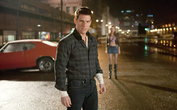 HD desktop wallpaper featuring Tom Cruise as Jack Reacher standing in a dimly lit street with a vintage car and a woman blurred in the background.