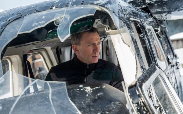 Daniel Craig as James Bond in a snowy helicopter scene from the movie Spectre, captured in stunning 4K Ultra HD for PC desktop wallpaper and background.