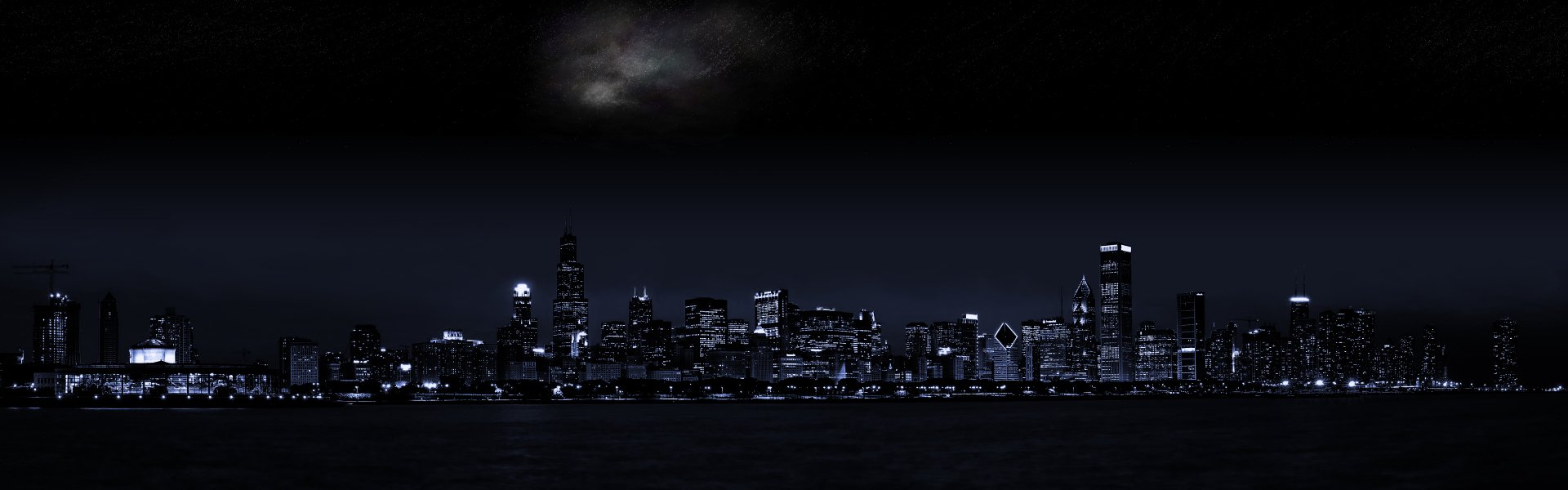 A high-definition desktop wallpaper showcasing the Chicago skyline at night, featuring illuminated buildings against a dark sky. The scene highlights the city's man-made beauty.