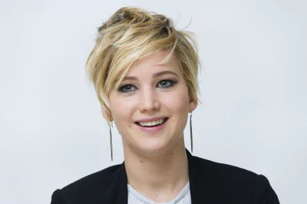 HD desktop wallpaper featuring Jennifer Lawrence, showcasing her vibrant smile and stylish short hair against a simple background. A captivating image of this celebrated celebrity.