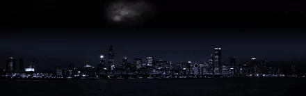 A high-definition desktop wallpaper showcasing the Chicago skyline at night, featuring illuminated buildings against a dark sky. The scene highlights the city's man-made beauty.