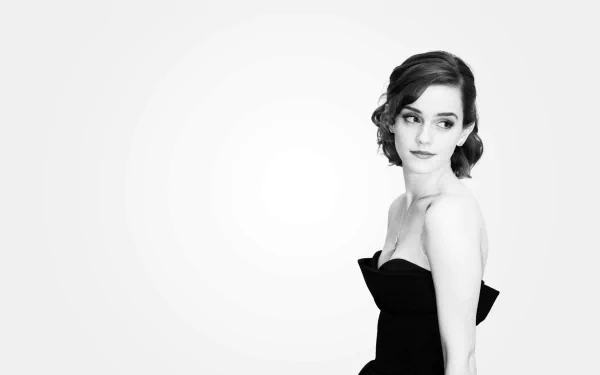 Black and white 4K Ultra HD desktop wallpaper of celebrity Emma Watson in an elegant, strapless black dress against a light background.