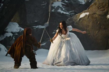 Lily Collins stars in Mirror Mirror, depicted in this HD wallpaper, showcasing a dramatic scene in a snowy landscape with a warrior preparing for a duel.
