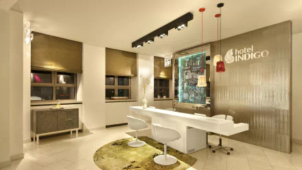 Hotel Indigo lobby room in Berlin — man-made hotel interior with white reception desk, pendant lights and textured wall; 4K Ultra HD PC desktop wallpaper/background.