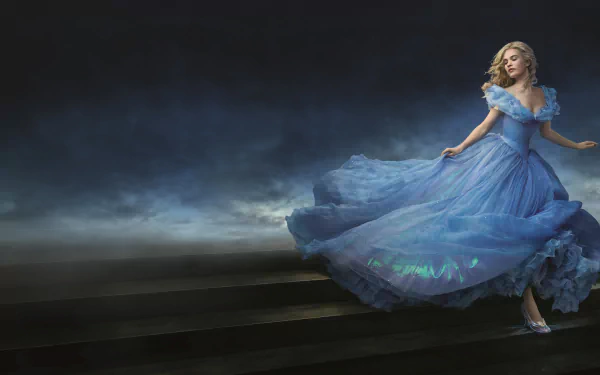 Lily James as Cinderella in a stunning blue gown, captured in an enchanting moment from the 2015 movie, set against a dramatic, ethereal backdrop. 8K Ultra HD wallpaper.