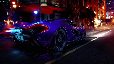 A high-definition desktop wallpaper showcasing a McLaren P1 car speeding down an illuminated urban street at night.