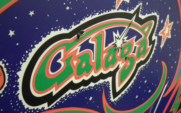 HD PC desktop wallpaper featuring the classic video game Galaga logo with vibrant colors and a starry outer space background.