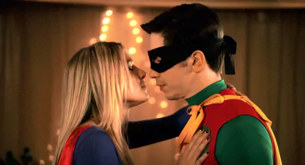 HD desktop wallpaper featuring Kristen Bell and Justin Long in superhero costumes from the movie Movie 43, sharing an intimate moment.